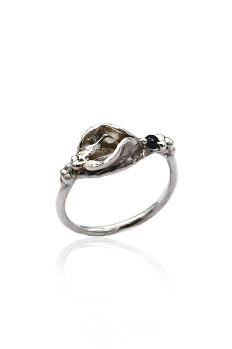 Jezebel Impurity Ring in sterling silver featuring an abstract vulva design with a dark blue sapphire accent, crafted using lost wax casting