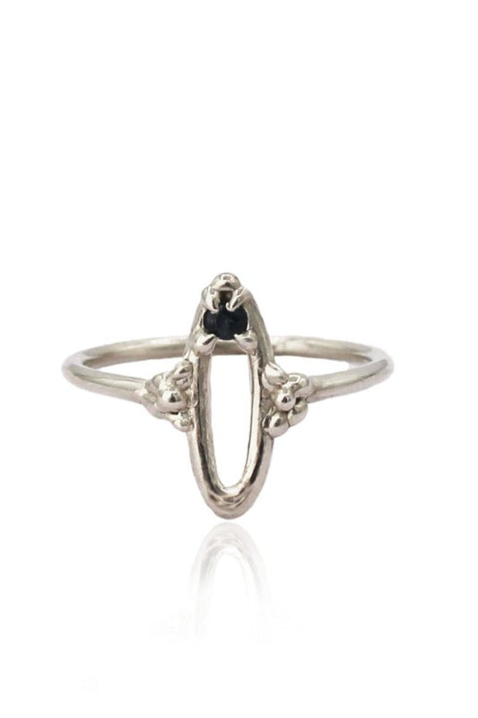 Sterling silver Bathsheba Impurity Ring with abstract yoni design and dark blue sapphire at the top.