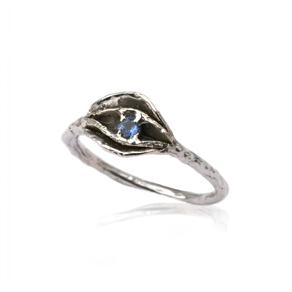 Georgia Impurity Ring in sterling silver with layered petal design surrounding a periwinkle sapphire, featuring a textured band and crafted using lost wax casting.