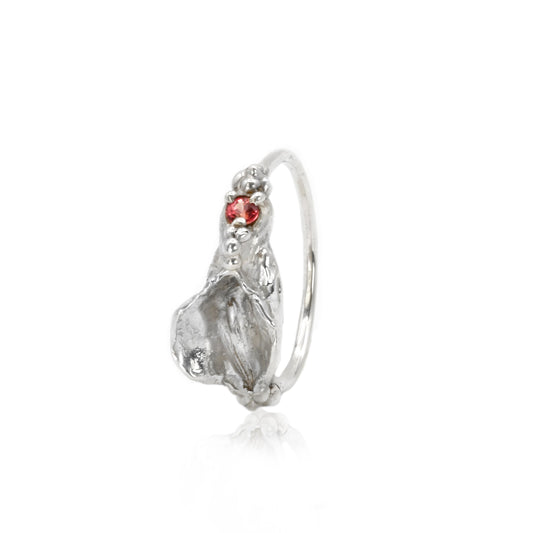 Silver vulva ring with a red sapphire on a white background by Impurity Culture jewelry