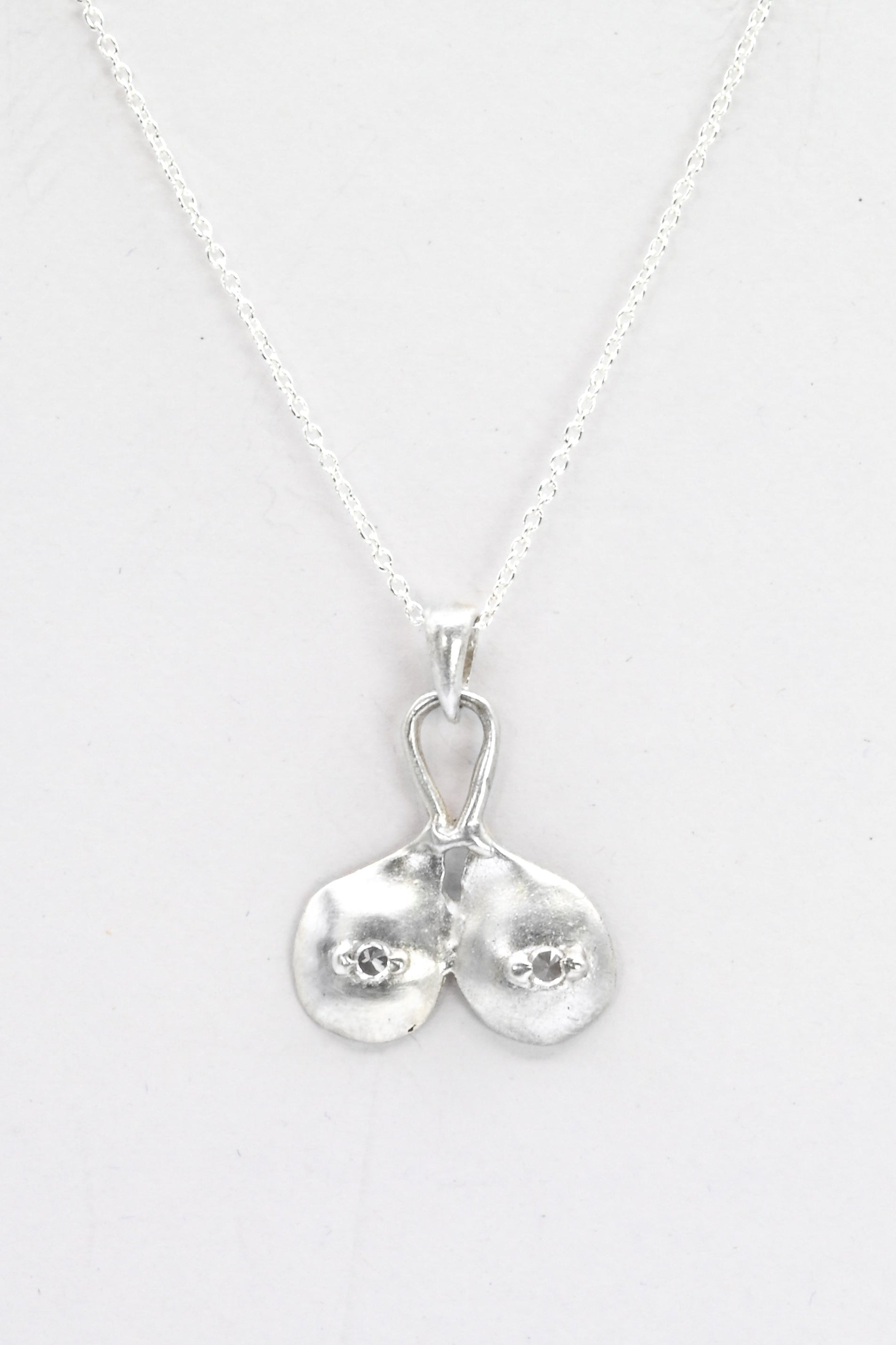 "Godiva" silver breasts pendant with white sapphire nipples, by Impurity Culture Jewelry