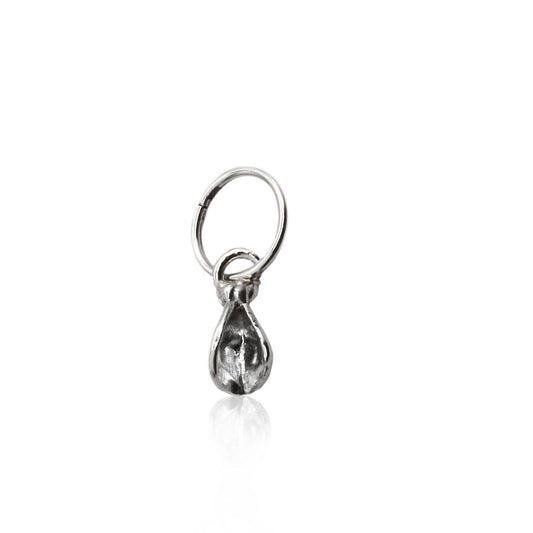 Marsha Huggie Hoop in sterling silver with a removable vulva charm, designed as a versatile single hoop for unisex styling.