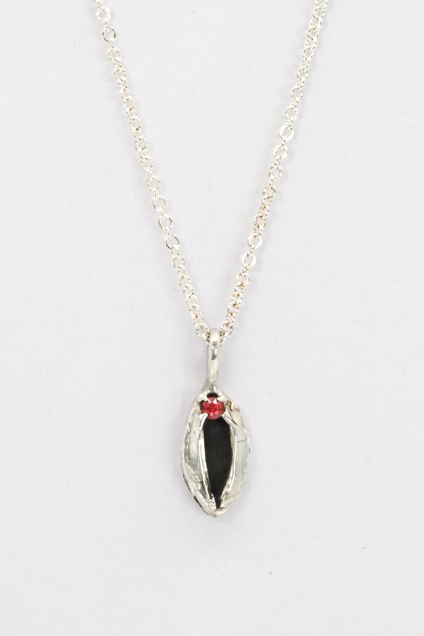 "Artemis" sterling silver cast vulva pendant with red sapphire clitoris by Impurity Culture Jewelry