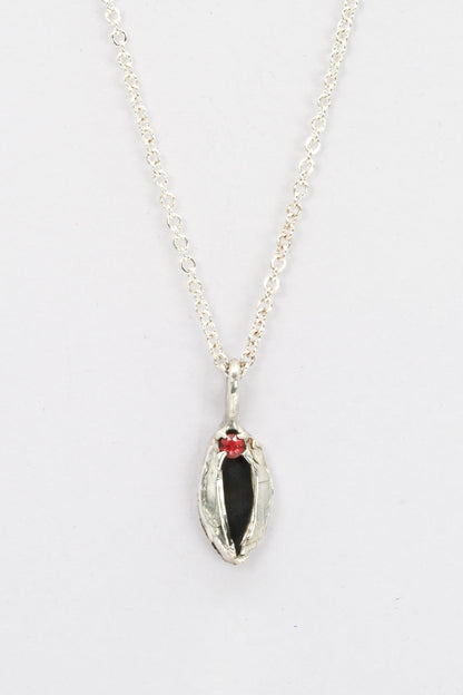 "Artemis" sterling silver cast vulva pendant with red sapphire clitoris by Impurity Culture Jewelry