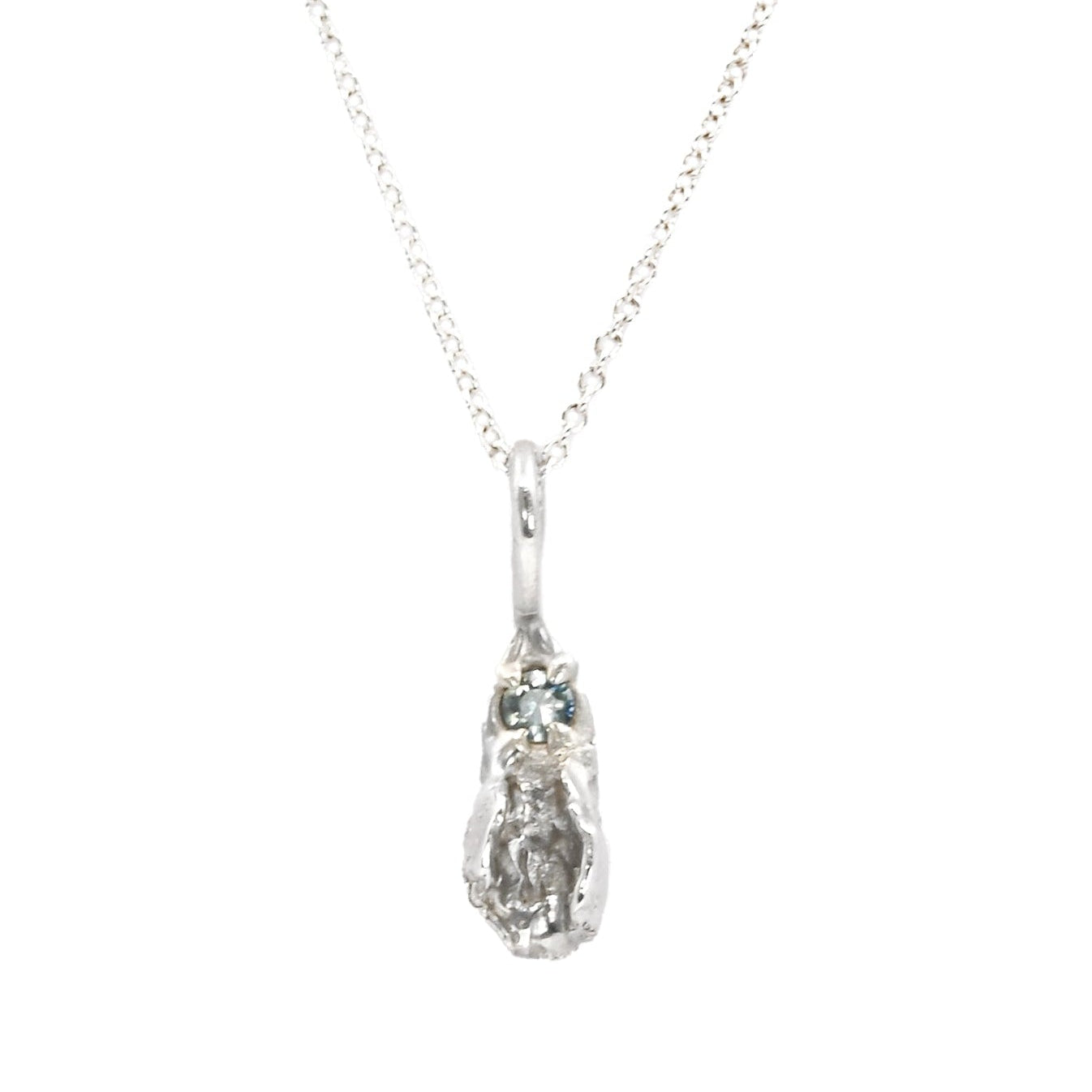 Tiny silver vulva pendant with light blue sapphire, feminist necklace by Impurity Culture Jewelry