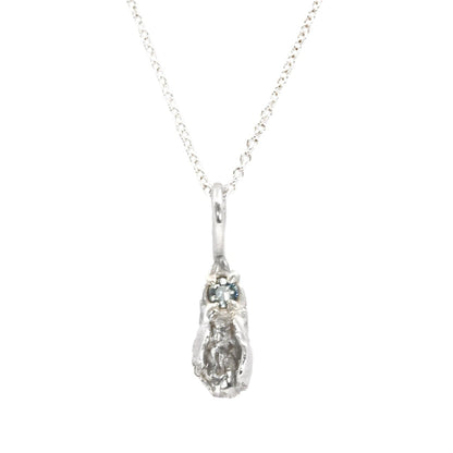 Tiny silver vulva pendant with light blue sapphire, feminist necklace by Impurity Culture Jewelry