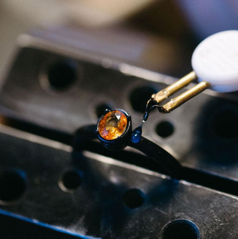 Orange sapphire set in a wax ring for lost wax casting with stones in place