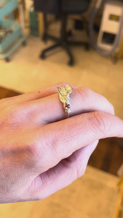Sterling silver impurity ring with a red sapphire modeled on a white woman's hand, by Impurity Culture jewelry
