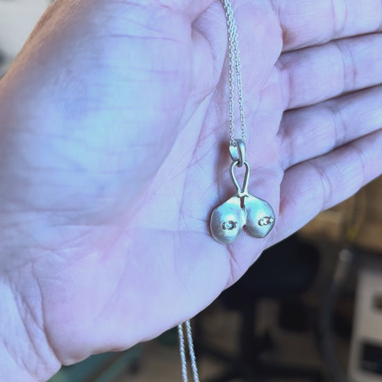 Sterling silver boobs necklace with white sapphire nipples, by Impurity Culture jewelry