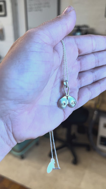 Sterling silver boobs necklace with white sapphire nipples, by Impurity Culture jewelry